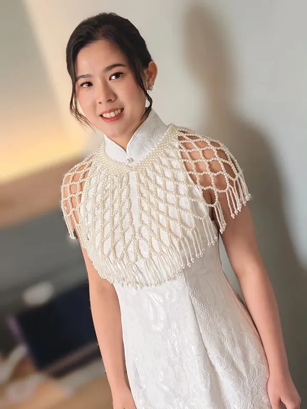 Bride in white qipao with pearl capelet, soft makeup and sleek bun by THEENG, Kuantan