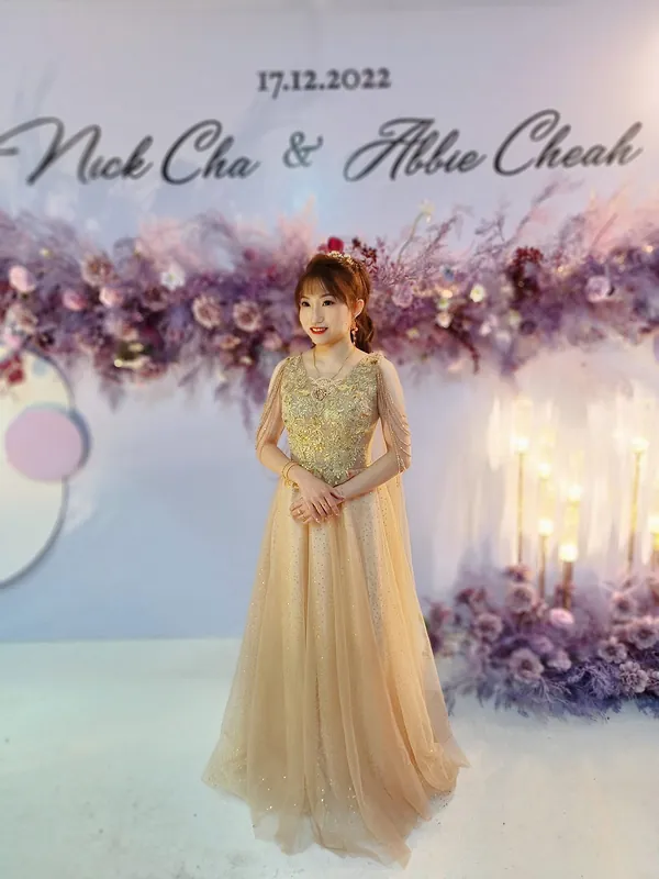 Full-length evening look in gold gown at a wedding dinner, makeup by THEENG, Kuantan
