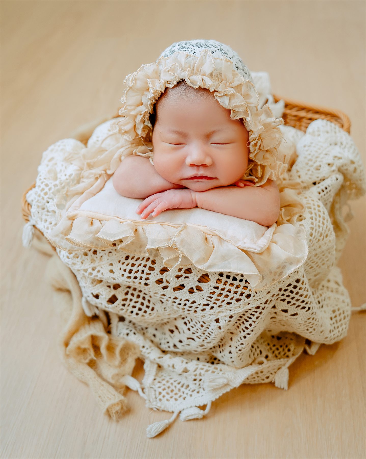 Newborn photography by Famous Bridal, sleeping baby in soft vintage lace basket styling