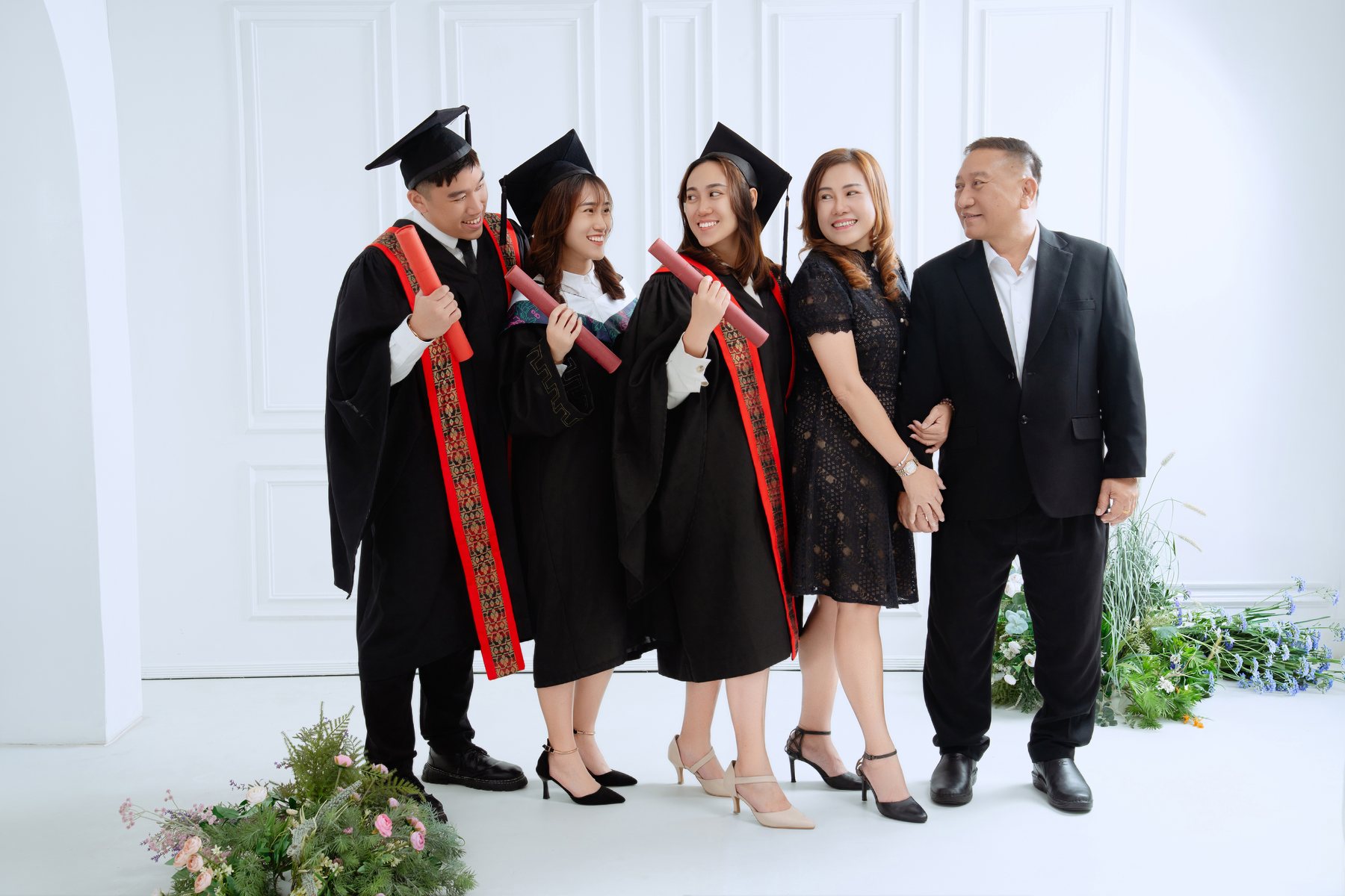 Graduate with parents and family in Kuantan studio