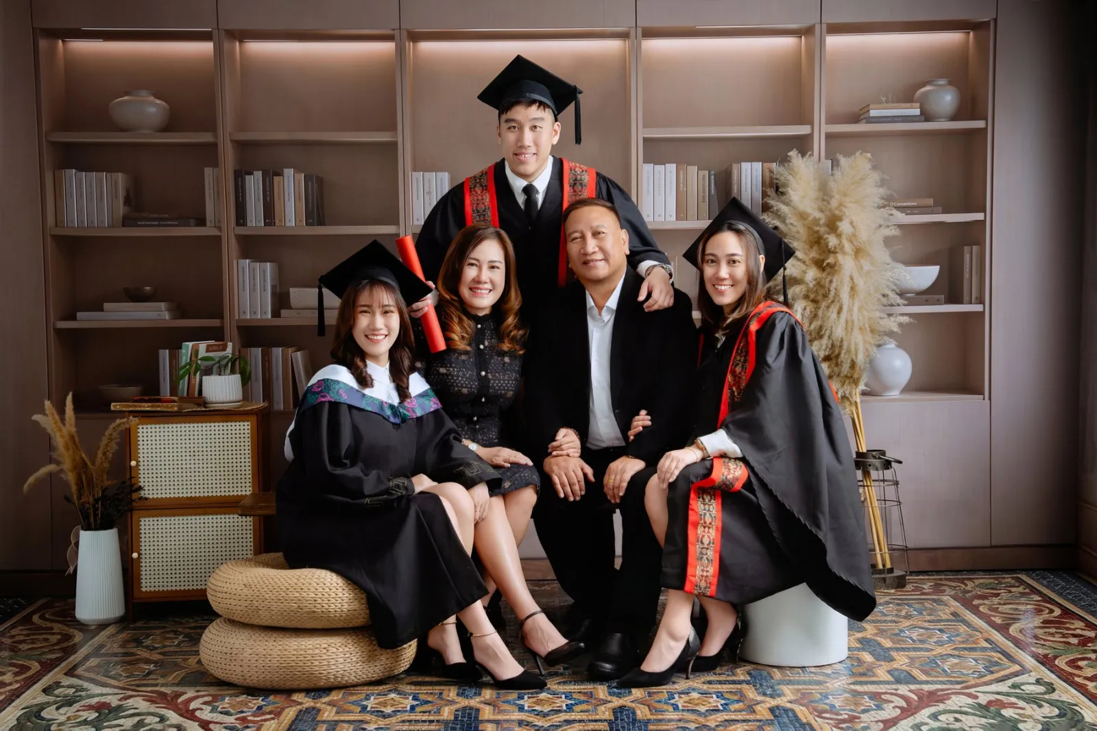 UMPSA graduate seated with family in Kuantan studio