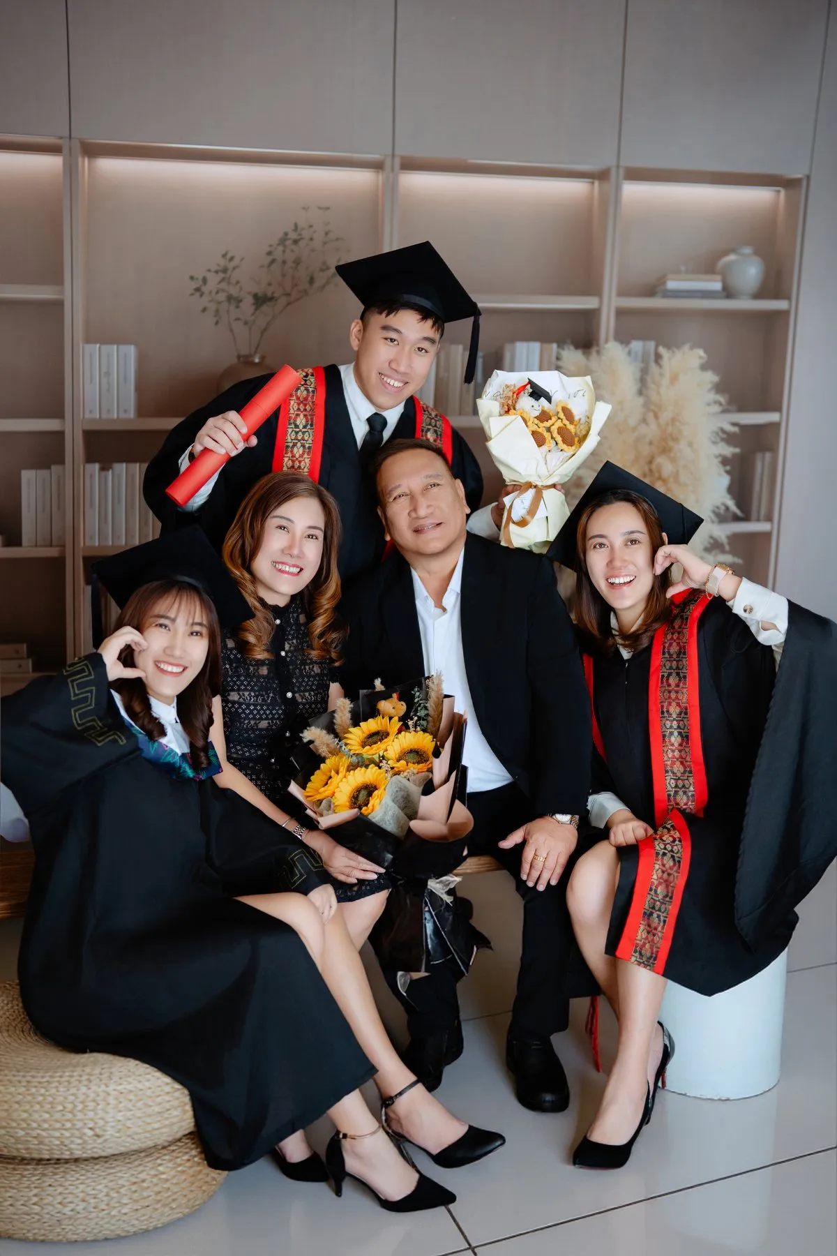 Graduate family portrait with bouquet and parents
