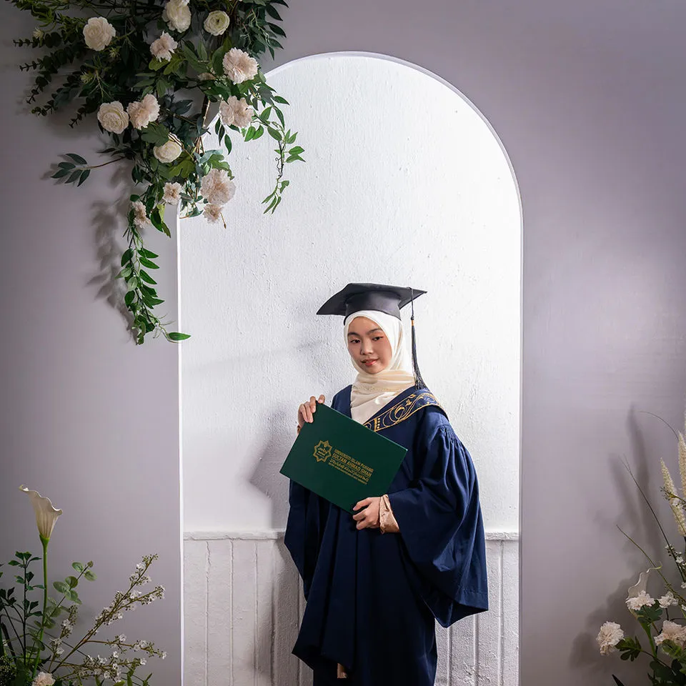 Graduate individual portrait with studio floral backdrop