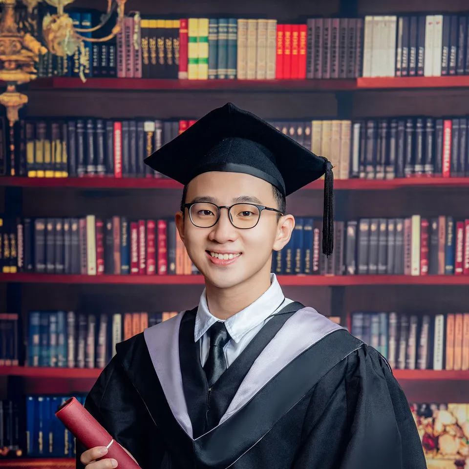 Close graduate portrait with diploma scroll